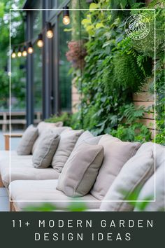 an outdoor seating area with couches and plants on the wall, surrounded by greenery