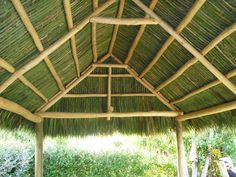 the inside of a hut with grass roof