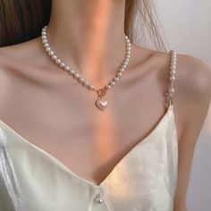 Toggle Clasp Heart Pendant Pearl Chain Choker Necklace This charming necklace features a delicate pearl chain with a lovely heart pendant and a convenient toggle clasp for easy wear. Enhance your look with a touch of romance and elegance. Silver Heart Jewelry, قلادات متدلية, Dainty Pearl Necklace, Diy Collier, Pearl Heart, Pearl Jewelry Necklace, Neck Jewellery, Pearl Choker Necklace, Valentines Necklace