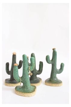 three small green cactus figurines sitting next to each other