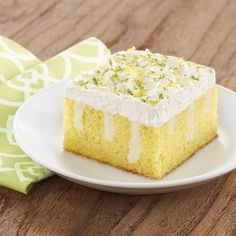 a piece of cake sitting on top of a white plate next to a green napkin