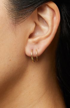 These hoops add the coolest detail to your look as they wrap around your ear, giving you the illusion of two piercings in one.How to wear: place thinner post through piercing. Turn earring approximately 2-3 times until both hoops are showing in the front to make a perfect double-pierced look. Avoid bending, style is delicate. Recycled Sterling Silver dipped in 14K Gold Delicate style, please handle with care Width: 5.5mm - 0.22" Depth: 13mm - 0.51" Weight: 0.60g Hoop Diameter: 13mm - 0.51” Post: Minimalist Gold Jewelry Earrings, Faux Double Hoop Earrings, Double Piercing Earrings, Two Piercings, Second Ear Piercing, Little Hoop Earrings, Double Earring, Double Earrings, Double Piercing