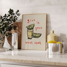 a kitchen counter with an art print on the wall above it that says give it your best shot