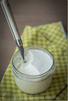 a spoon in a jar with some white powder