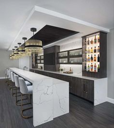 a modern kitchen with marble counter tops and bar stools