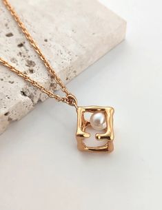 925 sterling silver coated gold vermeil necklace with hollow cube pendant freshwater pearl Quadrafoil Necklace, Gold Square Pendant Jewelry With Pearl, Gold Square Pearl Pendant Jewelry, Chic Gold Necklace With Square Pendant, Elegant Gold Plated Square Jewelry, Elegant Rectangular Pearl Pendant Necklace, Square Box Chain Necklace For Gift, Elegant Necklace With Square Pendant And Box Chain, Gold Necklace With Box Chain And Square Pendant