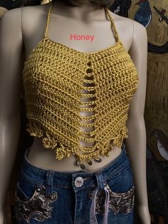 a mannequin wearing a yellow halter top with crochet details on it