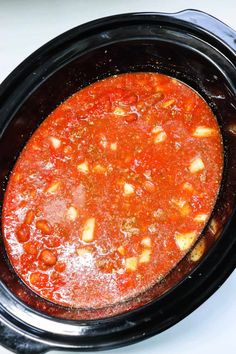 a crock pot filled with food sitting on top of a stove