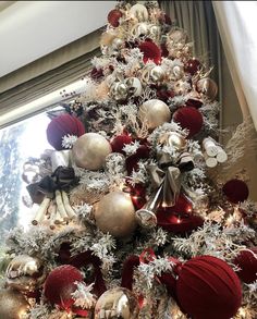 a christmas tree decorated with red and silver ornaments