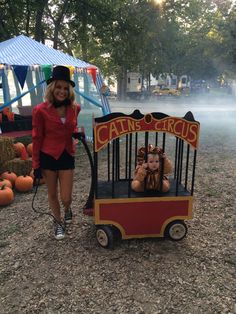 a woman standing next to a small cart with two babies in it on the ground