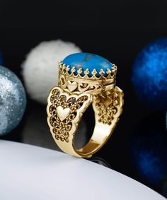 Add a pop of color to your jewelry collection with Filigranist's Gold Plated Sterling Silver Filigree Art Double Heart Detailed Turquoise Gemstone Women Statement Ring. Made from high-quality gold plated sterling silver, this ring features a stunning turquoise gemstone decoration that's sure to turn heads. The elegant filigree art design adds a touch of sophistication to any outfit, making it the perfect choice for any occasion. Express your unique sense of style and individuality with this eye- Unique Gold Turquoise Ring Gift, Turquoise Ring With Gemstone Accents As Gift, Blue Bohemian Jewelry With Accent Stones, Turquoise Ring With Accent Stones As Gift, Unique Turquoise Ring With Gemstone Accents, Unique Turquoise Ring With Gemstone Accents As Gift, Unique Yellow Gold Turquoise Ring For Gift, Gift Turquoise Ring With Accent Stones, Fine Jewelry Turquoise Cabochon Ring Gift