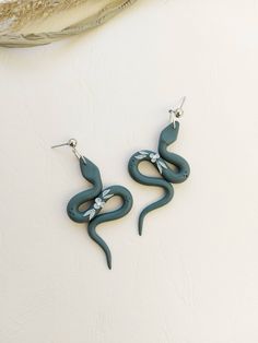 the earrings are shaped like a snake