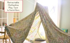 the tent is made from fabric and sits in front of a book shelf with books on it