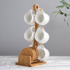 a wooden stand with cups on it and a plant in the background