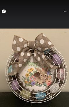 a basket with some eggs and a bow on it