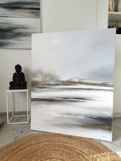 a painting is shown next to a small table