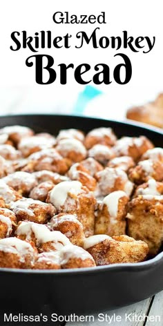 baked skillet monkey bread in a pan with white icing on top and cinnamon rolls