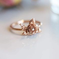 a rose ring sitting on top of a table