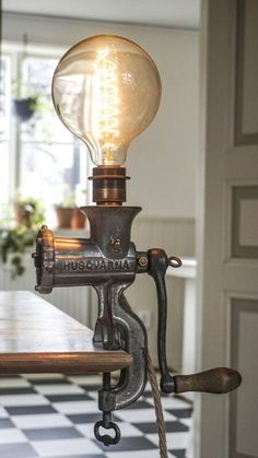 an old fashioned table lamp with a light bulb on it's arm and attached to the