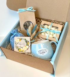 a box filled with lots of different types of items next to a card and gift bag