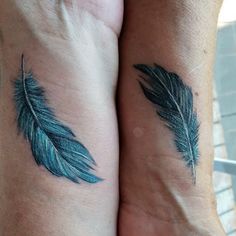 two blue feathers on both wrist tattoos