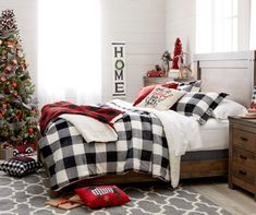 a bedroom decorated for christmas with plaid bedding