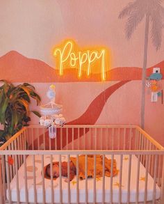 a baby's crib in front of a neon sign that says poppa