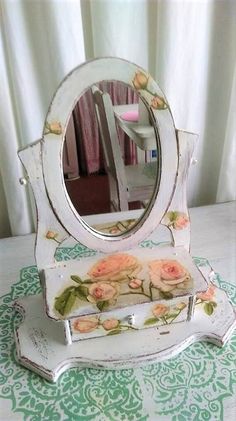 an old vanity mirror sitting on top of a table