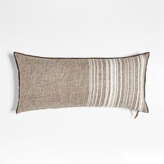 a brown and white striped pillow on a white wall