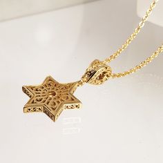 Elevate your personal style with our exquisite Gold-Plated Star of David Pendant, a symbol of faith and cultural significance. This pendant beautifully captures the essence of the Star of David, adorned with a captivating garnet or stone at its center, adding a touch of elegance and meaning to your jewelry collection. Measuring a graceful 1.8 inches (45 mm) in length and 0.8 inches (20 mm) in width, this pendant boasts intricate craftsmanship that showcases the star's delicate interlocking trian The Star Of David, Star Of David Necklace, Star Of David Pendant, Citrine Gemstone, Star Of David, The Star, Personalized Jewelry, Citrine, Garnet