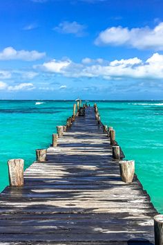 a long wooden pier extending into the ocean