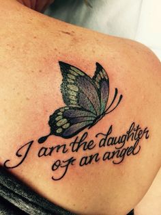 a woman with a butterfly tattoo on her back saying i am the daughter of an angel