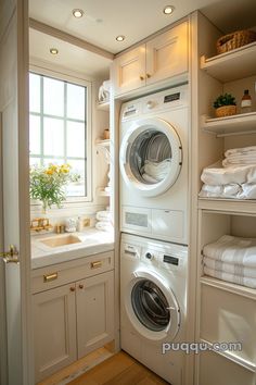 a washer and dryer in a small room next to some shelves with towels