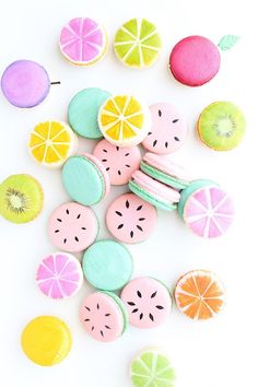 colorful cookies and candies are arranged on a white surface