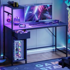 a desk with a computer on it in front of a purple wall and blue lights