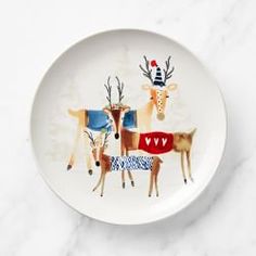 a white plate with deer and reindeer designs on it