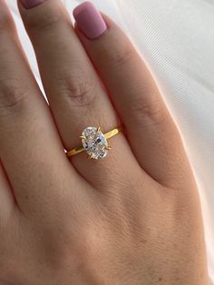 a woman's hand with a ring on it and a diamond in the middle