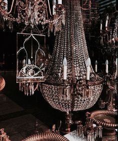 an ornate chandelier is hanging from the ceiling in a room filled with other items