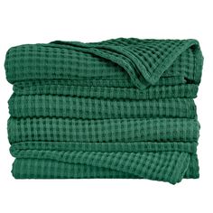 a stack of green towels folded on top of each other