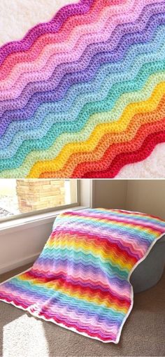 a crocheted rainbow blanket sitting on top of a floor next to a window