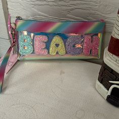 Nwt, Adorable Zip Pouch With “ Beach” On Front With Patch Lettering. Beautiful Pink Rainbow Colors, Detachable Wristlet Strap, Cute Hanging Heart Charm. Brand New! . Perfect For Your Vacays, Beach Travel Bags. Trendy Multicolor School Pouch, Pink Summer Pouch, Cute Multicolor Travel Pouch, Trendy Summer Beach Pouch, Trendy Summer Travel Pouch, Multicolor Rectangular Summer Pouch, Multicolor Rectangular Pouch For Summer, Trendy Beach Pouch For Summer, Rectangular Multicolor Summer Pouch