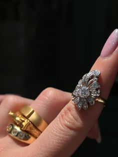 Playful yet elegant, this vintage Retro “Plume” Cluster Ring is a remarkable statement piece. Crafted circa 1940’s, this ring is a glimmering example of the ways 1940’s jewelry continued some of the Belle Epoque design traditions. Note the striking 14 carat yellow gold body of the ring, which juxtaposes beautifully against the 14 carat white gold top. Also beautiful are the cluster of vivid white miniature diamonds, which are arranged in a labyrinthine halo around the pièce de resistance – a gor Art Deco Diamond Cluster Ring With 17 Jewels, Art Deco Diamond Rings For Vintage Events, Antique Jewelry With Center Stone For Vintage Events, Art Deco Rings With Center Stone For Vintage Events, Vintage Brilliant Cut Jewelry For Evening, Vintage Jewelry With Brilliant Cut For Evening, Art Deco Rings For Vintage Events With Round Cut, Art Deco Round Cut Rings For Vintage Events, Heirloom Yellow Gold Rings For Vintage Events