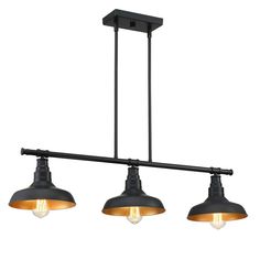 three lights hanging from the ceiling in an industrial style with black and gold fixtures,