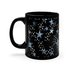 a black coffee mug with blue and white stars on it