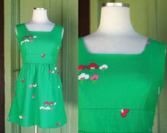 Lovely Dress by Malia Honolulu Circa 1970s Green with Pink & White Mod Floral Design  Scoop Neckline Sleeveless Darting at Bust Waist Band (I believe it hits above natural waist, but please see all measurements - since it is so petite it may fit different than I think. lol) Ties at Back of Waist Gathers Across Bottom of Waist Band Hip Pockets Micro Mini Length Center Back Zip **dress has been shortened - there is not extra seam allowance to be let down. a few minor spots of wear that present a bit like fuzz. dress presents very well overall.  Label: Malia Honolulu Tag size may not be accurate to current day sizing, please refer to garment's measurements. Garments are measured laying flat - measurements doubled as necessary. Chest: 31 in Shoulder to Top of Waistband: 11 in Empire Waist/Unde 1970s Style Green Summer Dresses, Fitted 1970s Mini Dress, Mid-century Sleeveless Cotton Dress, 1970s A-line Summer Dress, 1970s Style Sleeveless Cotton Dress, Yellow Plaid Shirt, Red Tuxedo, African Print Jumpsuit, 1970s Green Floral Print Dress