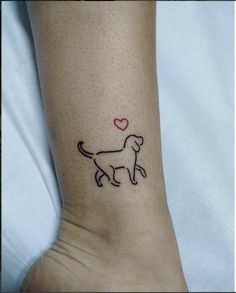 a small dog with a heart on it's side tattooing its paw and foot