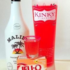 a bottle of vodka next to a carton of peach juice and a glass filled with water