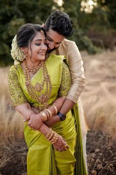 a man and woman hugging each other in a field