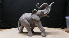 an elephant figurine is shown on a table