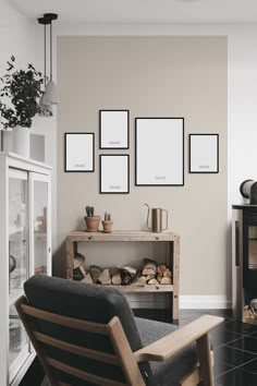 a living room filled with furniture and framed pictures on the wall above a fire place